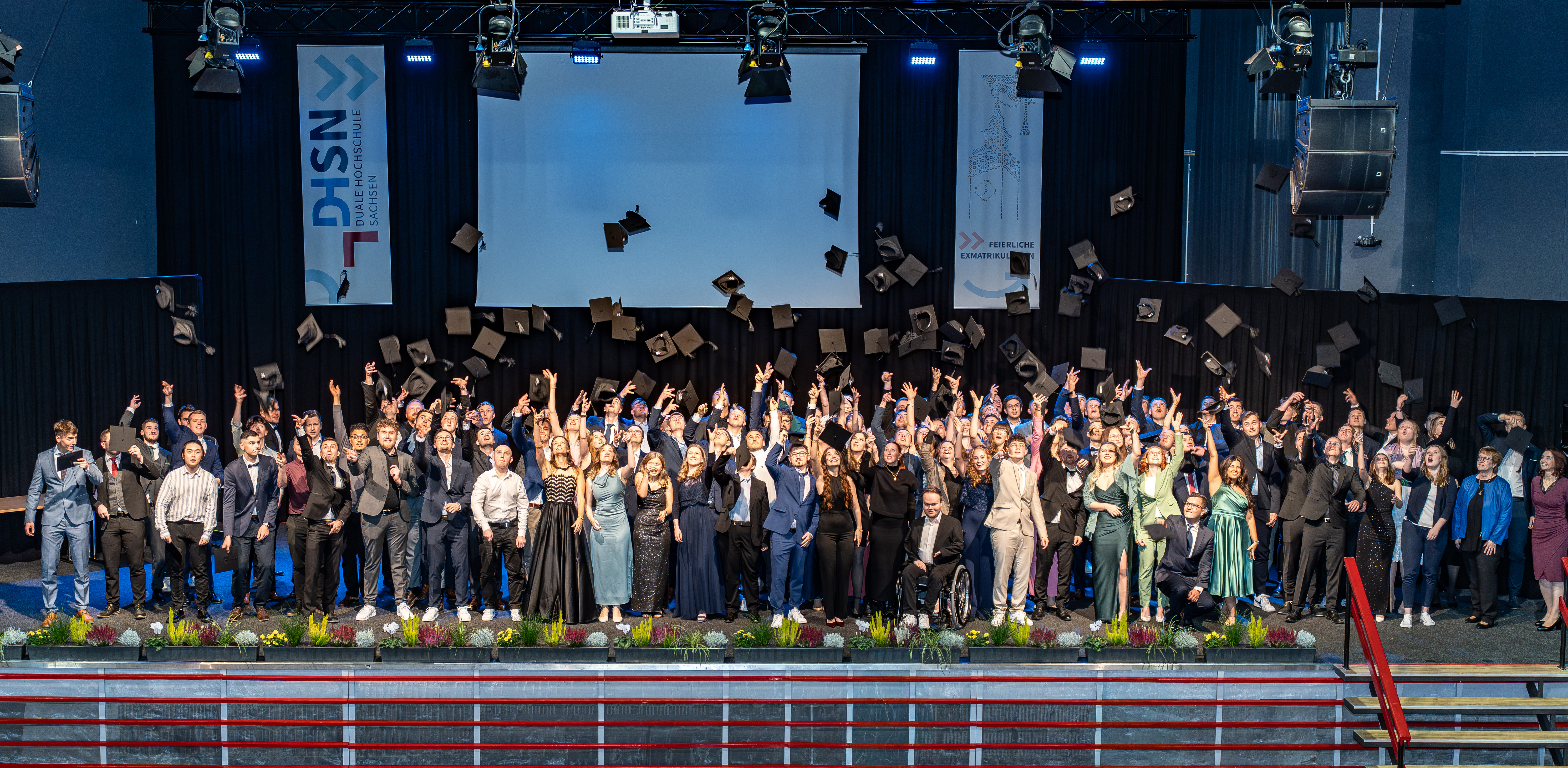 Absolventen werfen Bachelorhüte in die Luft